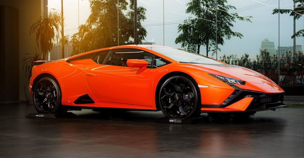 pexels-photo-17632044-17632044 A sleek orange Lamborghini Huracan sports car parked indoors with urban views.